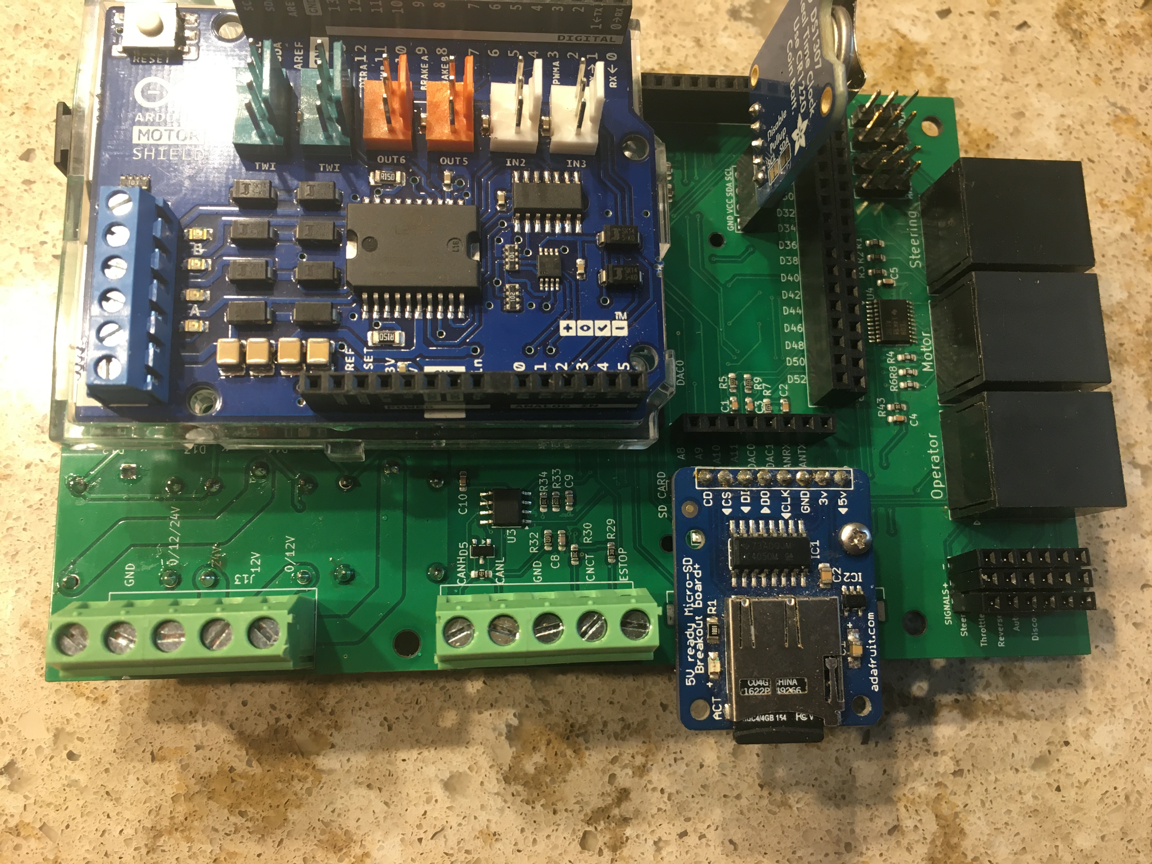 Version 5.0 of the drive-by-wire board with a motor controller shield for steering.